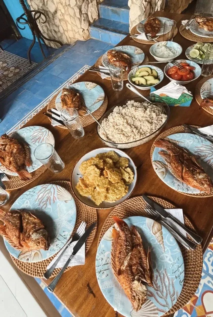Fresh Caribbean lunch with whole local fish, coconut rice, and fried plantains at Casa Gaviota Barú