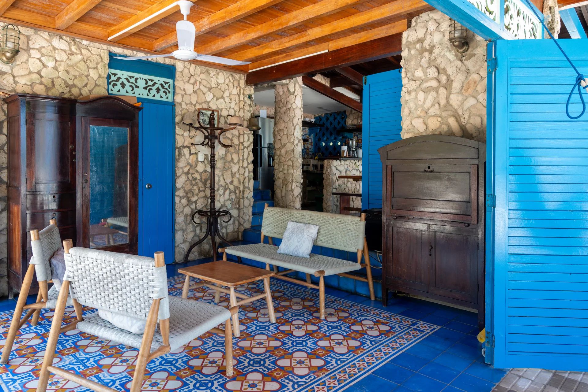 Open-air living lounge at Casa Gaviota with wicker sofas, patterned tiles, and Starlink Wi-Fi